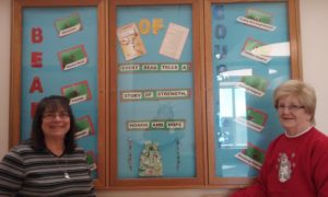 Ruth and Carol in front of Beads of Courage Bulletin Board